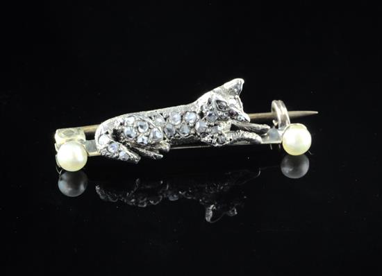 A Victorian gold and silver, rose cut diamond and seed pearl set brooch, modelled as a recumbent fox, 1.25in.
